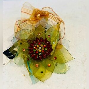 New with tags pretty ribbon bracelet. Beaded rhinestone flower centre design.
